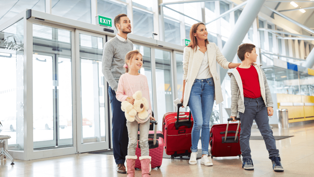 A family pulling luggage as they arrive at the airport overseas