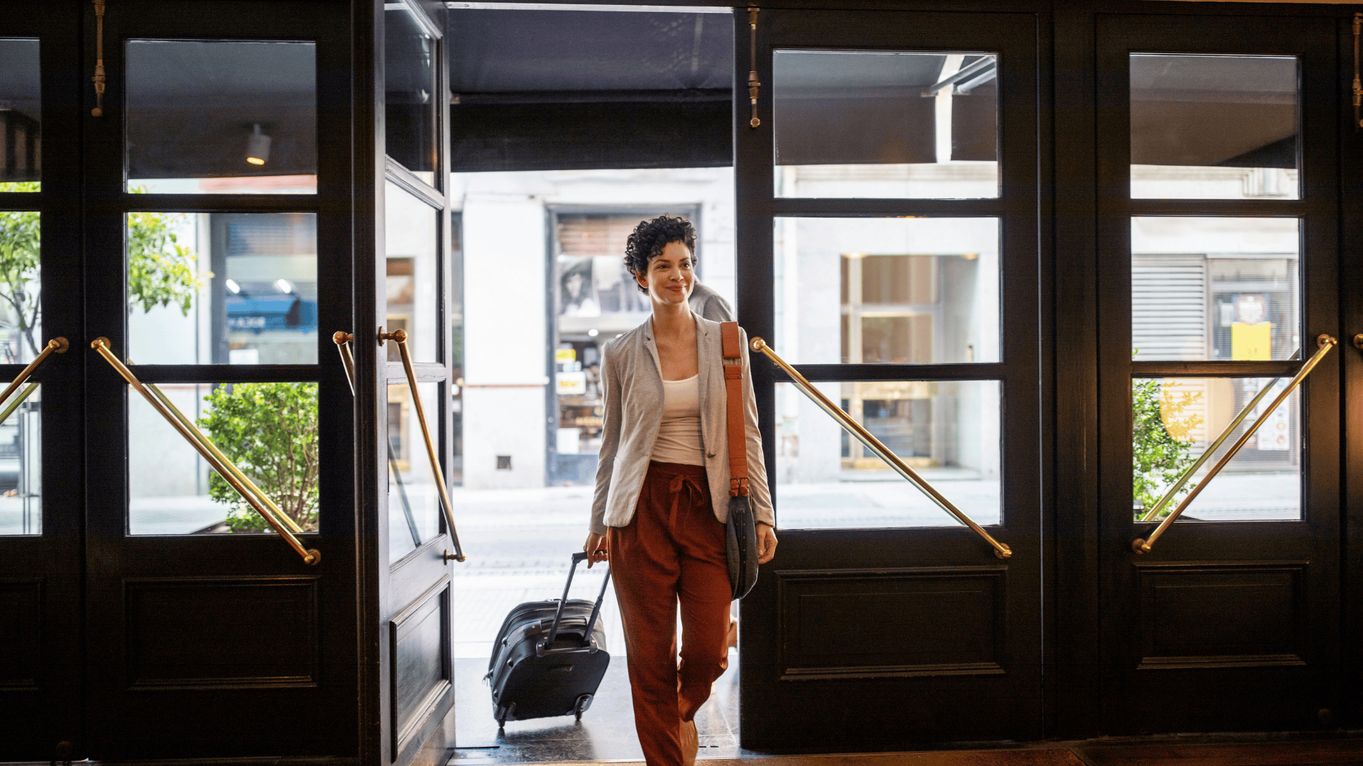 A professional arriving overseas with a rolling suitcase