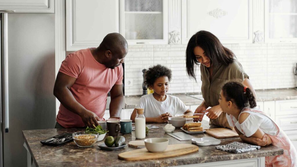 A family enjoying cooking together in their home