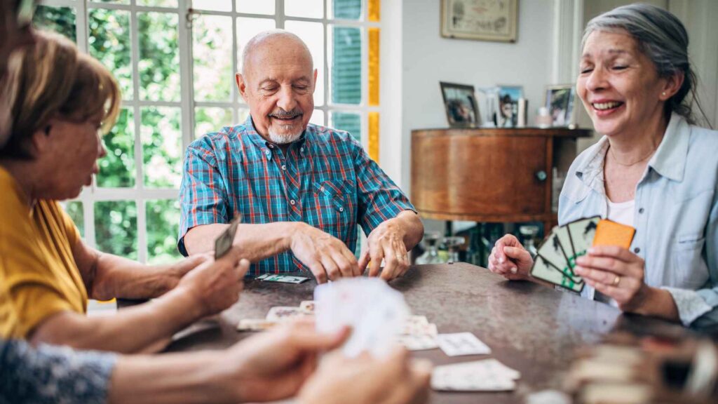 A group of friends playing cards together at home