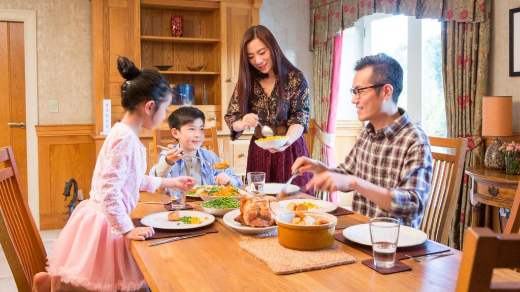 Family enjoying a home-cooked dinner together at their dining table 