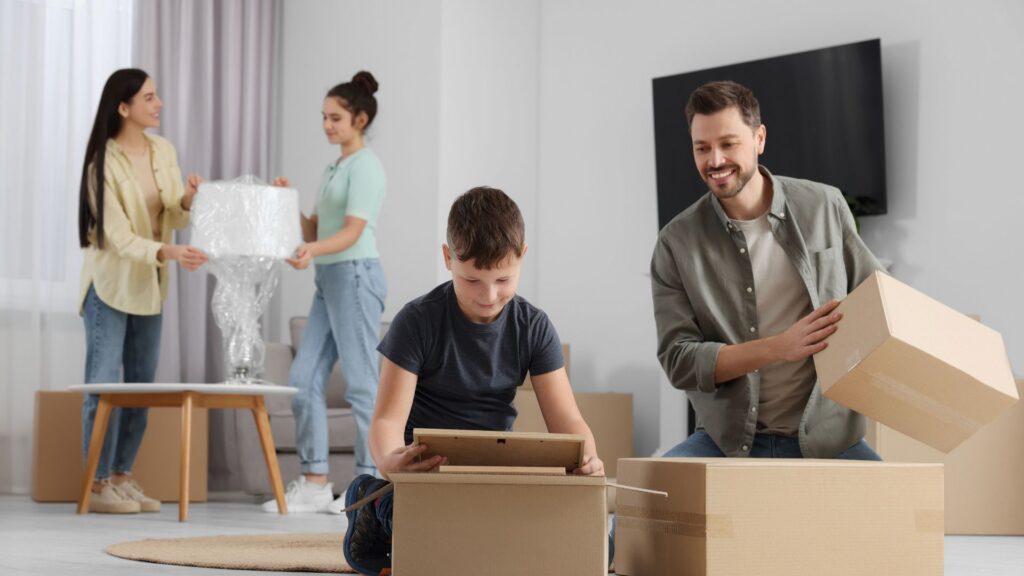 Family unpacking boxes into their new home overseas