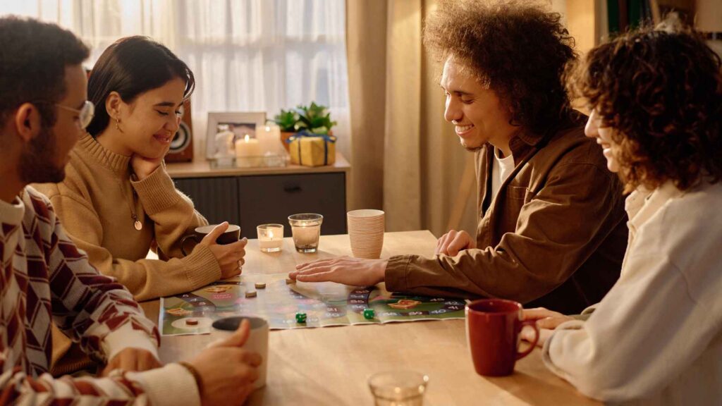 Four friends spending an evening together at home over a board game.