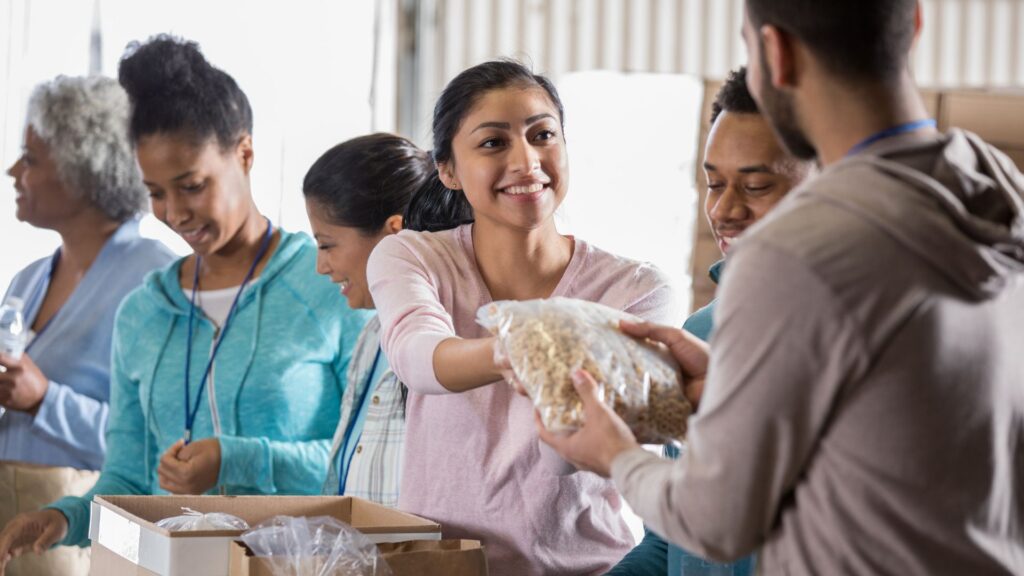 A group of faith-based team volunteers packing donation supplies together before a trip.