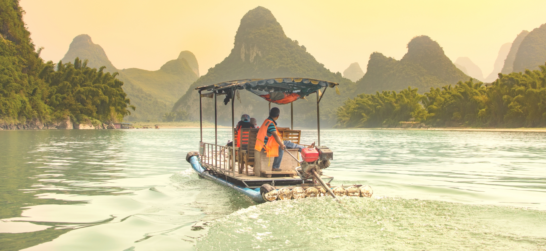 covered pontoon boat on water