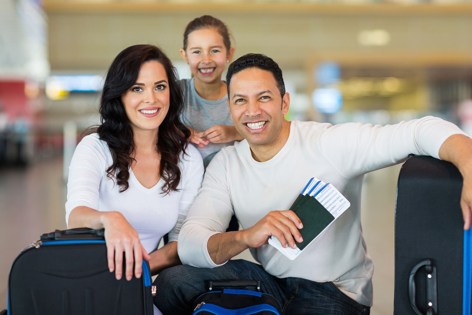 husband wife and child at airport