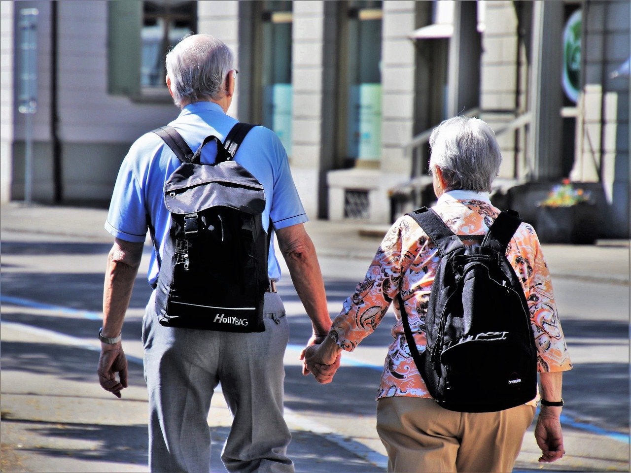 elderly-man-woman-traveling-with-backpacks