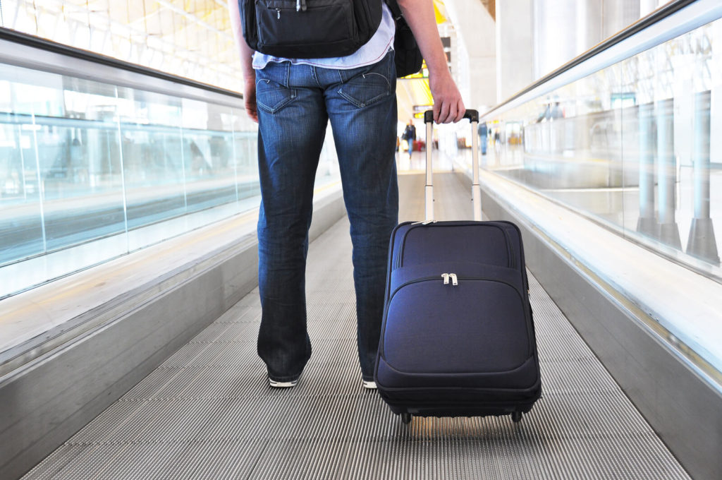 traveler with bag in airport