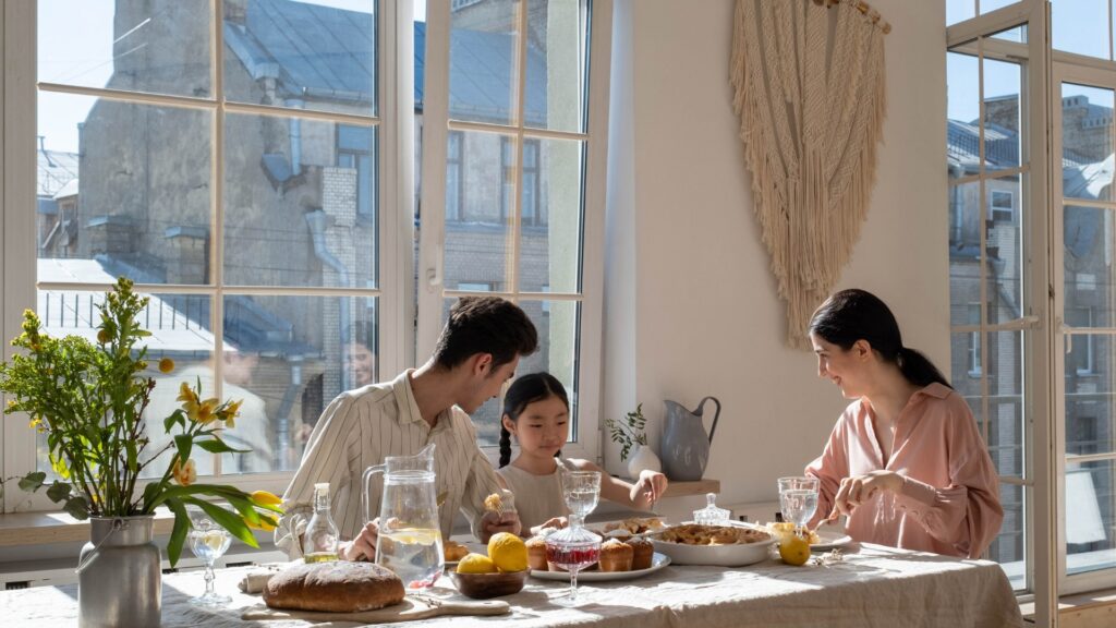 A family of three sharing a meal together at home.